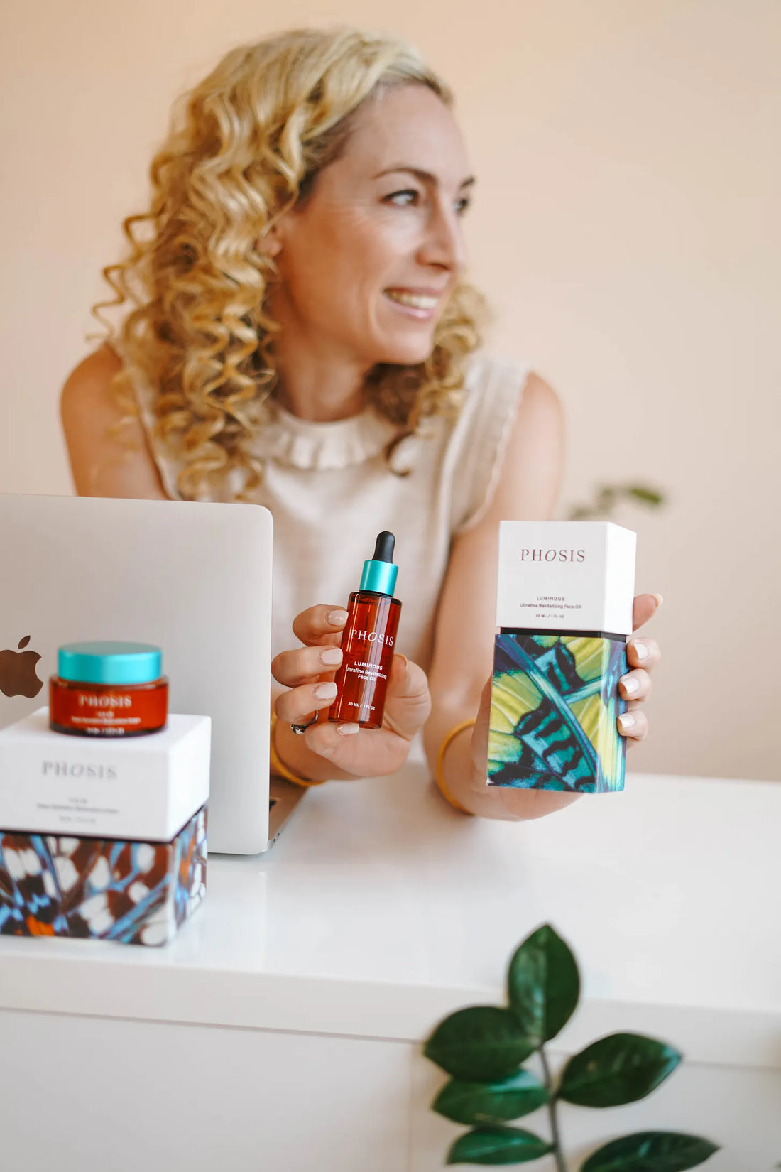 Susan Campbell holding Phosis skincare products