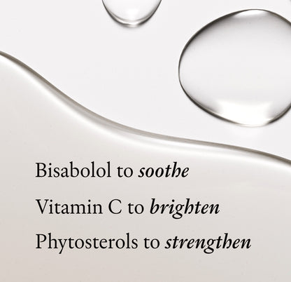 Drops of pale colored face oil il on white background